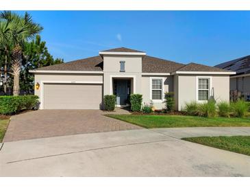 Charming one-story home with a brick driveway, well-maintained landscaping, and a two-car garage at 3375 Hanging Tide St, Winter Garden, FL 34787