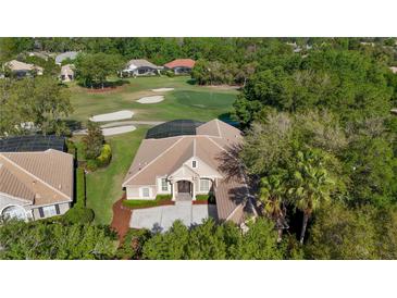 Stunning single-story home featuring a well-manicured lawn and located on a picturesque golf course at 3400 Park Grove Ct, Longwood, FL 32779
