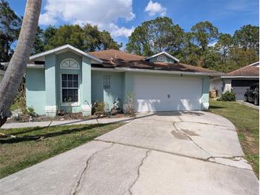 Charming single-story home features a two-car garage and well-maintained landscaping at 4798 Windwood Dr, Kissimmee, FL 34746