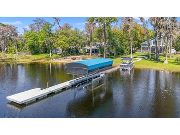 Picturesque waterfront home featuring a private boat dock, lift, and stunning lake views at 5824 N Dean Rd, Orlando, FL 32817