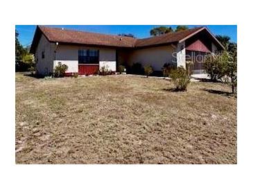 Charming single-story home featuring a well-maintained exterior with a large front yard at 604 Tradewinds Dr, Deltona, FL 32738