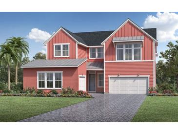 Charming two-story home with a red exterior, two-car garage, landscaped yard, and a paved driveway at 6244 Trailblaze Bnd, St Cloud, FL 34771