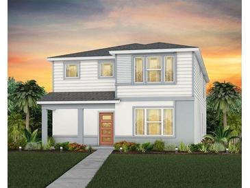Charming two-story home with white siding and a well-manicured lawn and walkway at 7006 Rosy Sky Ave, Orlando, FL 32829