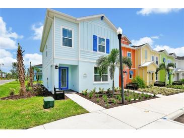 Charming, colorful two-story home with landscaped front yard and walkway at 8199 Coconut Pl, Kissimmee, FL 34747