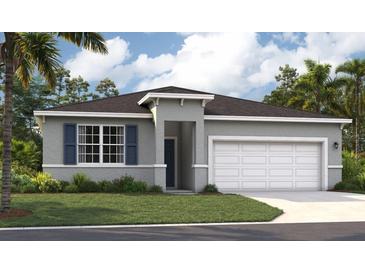 Beautiful single-Gathering home featuring a two-car garage, well-maintained lawn, and classic architectural details at 1355 Wood Line Loop, Deland, FL 32720