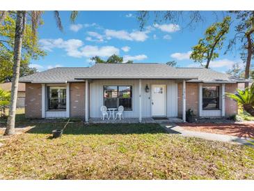 Charming single-story home featuring a well-maintained front yard with a lovely entryway and seating area at 1510 Chatsworth Ave, Deltona, FL 32738