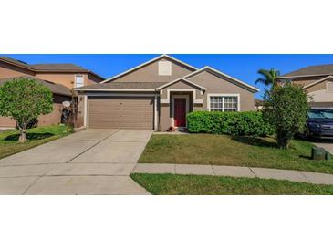 Charming single-story home with well-maintained lawn and two-car garage at 15279 Sugargrove Way, Orlando, FL 32828