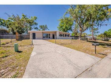 Charming single-story home with a long driveway and a well-maintained front yard at 3706 Wade Rd, Orlando, FL 32808