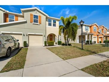 Charming townhome with well-maintained landscaping, a driveway and a welcoming curb appeal at 5117 Killarney Way, Kissimmee, FL 34746