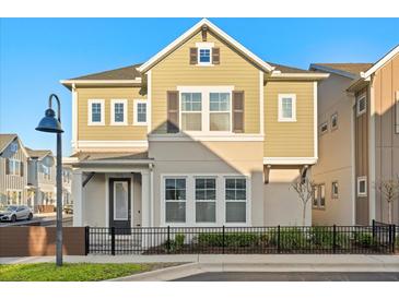 Charming two-story home with manicured lawn and black metal fence at 543 Wishbone Ln, Lake Mary, FL 32746