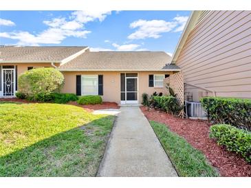 Charming single-story home with manicured lawn and inviting walkway at 1236 Villa Ln # 143, Apopka, FL 32712