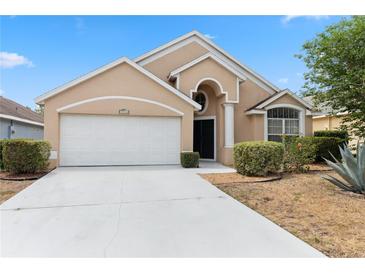 Charming single-story home with a well-maintained front yard and attached two-car garage at 15746 Autumn Glen Ave, Clermont, FL 34714