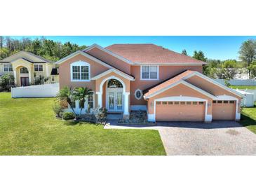 Charming two-story home featuring lush landscaping and a three-car garage at 2629 Maggiore Cir, Kissimmee, FL 34746