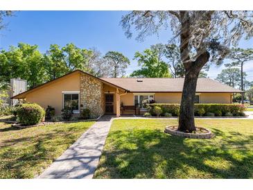 Charming single story home with stone accents, lush landscaping and a welcoming front entry at 300 Radebaugh Dr, Longwood, FL 32779