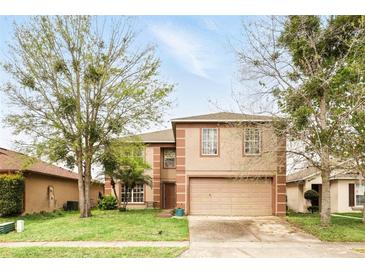Charming two-story home with a two-car garage, well-maintained lawn, and mature trees offering shade at 750 Sterling Spring Rd, Orlando, FL 32828