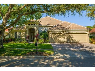 Charming single-story home with a well-manicured lawn and a spacious three-car garage at 8912 Heritage Bay Cir, Orlando, FL 32836
