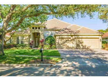 Beautiful single-story home with manicured lawn and mature shade tree at 8912 Heritage Bay Cir, Orlando, FL 32836