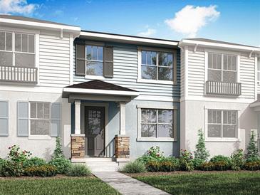 Charming townhome featuring a covered porch, stone accents, and a well-manicured front yard at 1287 Tarflower Dr, Winter Springs, FL 32708