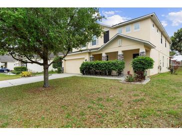 Inviting two-story home with a well-manicured lawn and stone-accented entryway at 1304 Independence Ln, Mount Dora, FL 32757