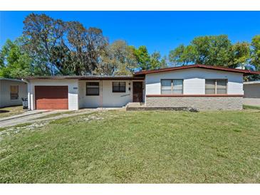 Charming single-story home featuring a well-maintained lawn and a one-car garage at 1807 Yorkshire Dr, Winter Park, FL 32792