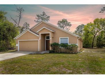 Charming single Gathering home boasts a two-car garage and a well-maintained lawn at 3199 Quail Dr, Deltona, FL 32738