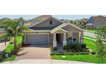 Beautiful single-Gathering home featuring a brick driveway, manicured lawn, and covered front porch at 5052 Blanchard Ct, St Cloud, FL 34772