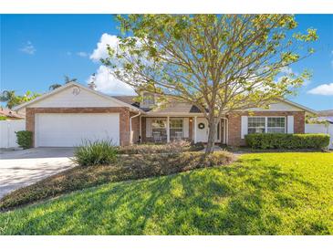 Charming single-Gathering home with brick accents, lush landscaping, and a welcoming front porch at 5263 Jade Cir, Belle Isle, FL 32812