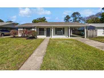 Charming single-story home with a well-maintained lawn and covered parking at 5618 Carris Ct, Orlando, FL 32810
