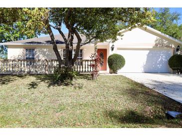 Charming home featuring a manicured front yard, a decorative fence and a well-maintained lawn at 7 Sequoia Way, Kissimmee, FL 34758