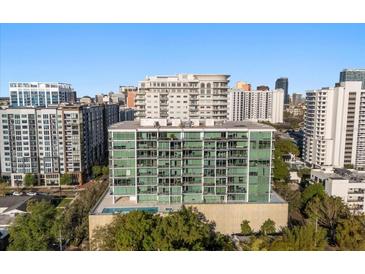 Stunning exterior view of a modern high-rise apartment building with beautiful architecture at 101 S Eola Dr # 902, Orlando, FL 32801