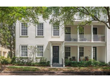 Charming two-story townhouse with a balcony, manicured landscaping, and beautiful curb appeal at 1563 Common Way Rd, Orlando, FL 32814