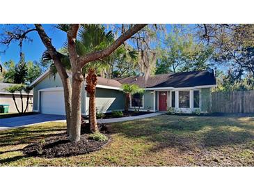 Charming single Gathering home with manicured landscaping and a vibrant red front door at 213 Almaden Ct, Winter Springs, FL 32708