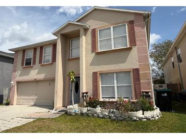 Charming two-story house featuring a well-kept lawn, neutral paint, and classic shutters at 3024 Natoma Way, Orlando, FL 32825