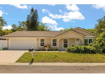 Charming single-story home featuring a well-manicured lawn and an attached two-car garage at 704 Briarwood Dr, Winter Springs, FL 32708