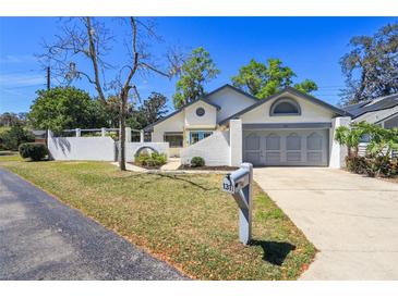 Charming one-story home with attached garage, well-maintained lawn and landscaping in a quiet neighborhood at 1311 Harbour Dr, Longwood, FL 32750