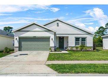 Charming single-Gathering home with a well-manicured lawn and a two-car garage in a quiet neighborhood at 17668 Passionflower Cir, Clermont, FL 34714