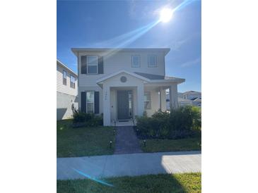 Charming two-story home with manicured lawn, walkway and covered entry at 3954 Great Smokey Way, Apopka, FL 32712