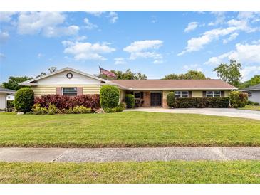 Charming single-story home with mature landscaping and well-maintained lawn at 4231 Yorketowne Rd, Orlando, FL 32812