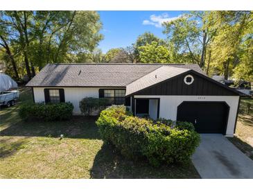 Charming single-story home featuring a one-car garage, tidy landscaping, and neutral colors at 6713 Cherry Rd, Ocala, FL 34472