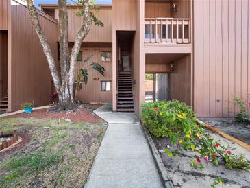 Inviting condo exterior featuring a walkway and lush landscaping with a well-maintained facade at 1092 E Michigan St # 1, Orlando, FL 32806