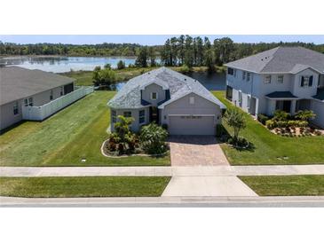 Charming single-Gathering home boasts a beautifully landscaped yard and serene water views at 16781 Meadows St, Clermont, FL 34714