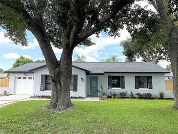 Charming one-story home with a brick exterior, a well-manicured lawn, and a delightful turquoise front door at 170 Lady Susan Ct, Casselberry, FL 32707