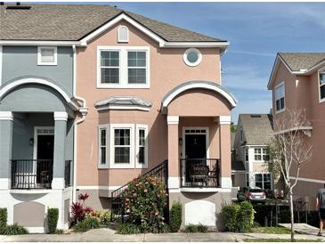Charming two-story townhome with a front porch and meticulously maintained landscaping at 6575 Time Square Ave # 101, Orlando, FL 32835