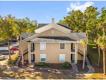 Exterior view of a two story condo building with stairs and walkway at 1013 S Hiawassee Rd # 3628, Orlando, FL 32835