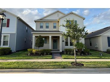 Charming two-story home with a well-manicured lawn and inviting front porch at 15872 Moonlight Bay St, Winter Garden, FL 34787