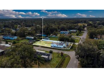 An aerial view of a charming home with a well-maintained yard and surrounding lush greenery at 18302 15Th Ave, Orlando, FL 32833