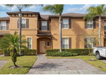 Charming two-story townhome with lush landscaping and paved driveway at 3132 Calabria Ave, Davenport, FL 33897