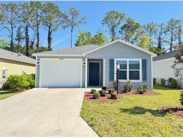 Charming single-story home with a well-manicured lawn and attached one-car garage at 3437 Possehl Pl, The Villages, FL 32163