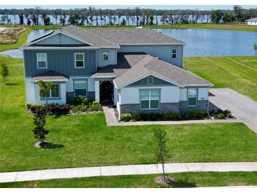 Beautiful two-story home featuring manicured lawn and picturesque water view, perfect for serene living at 4512 Cutwater Dr, Orlando, FL 32820