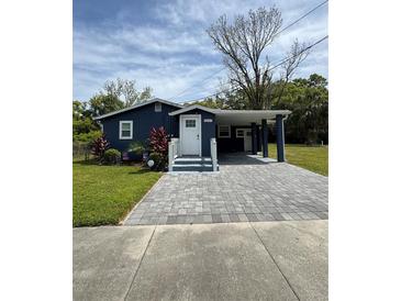 Charming single story home with navy blue paint, white trim and an ample driveway with parking at 5237 Davisson Ave, Orlando, FL 32810